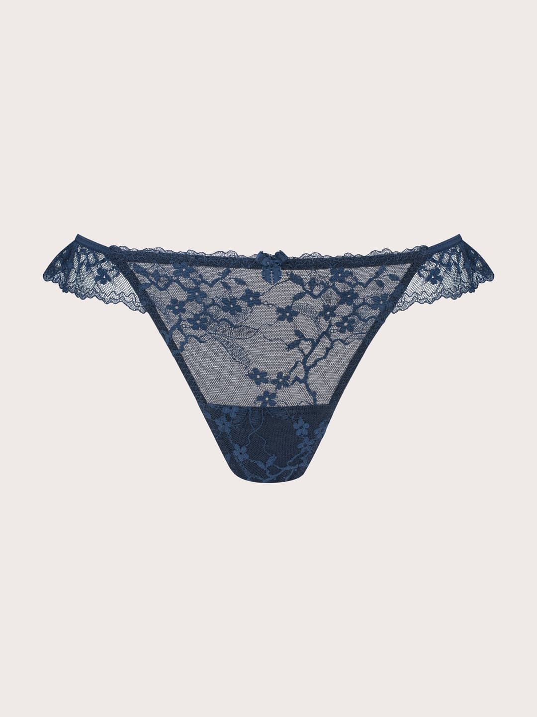 A pair of navy blue lace thong panties with a floral lace pattern and ruffled trim, displayed flat against a light beige background.